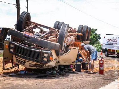 Caminhão tomba, cabine fica destruída e carga atinge mãe e filha