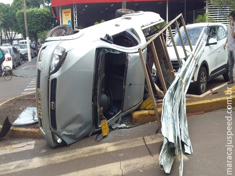 Carro capota após colisão e atinge outro veículo que estava estacionado