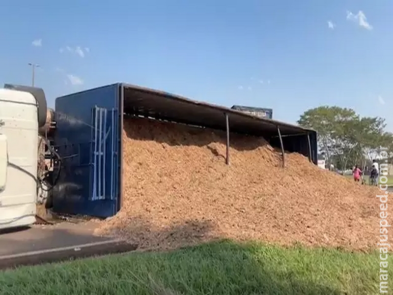 Carreta com resíduo de eucalipto tomba em rotatória e deixa trânsito lento Carreta com resíduo de eucalipto tomba em rotatória e deixa trânsito lento