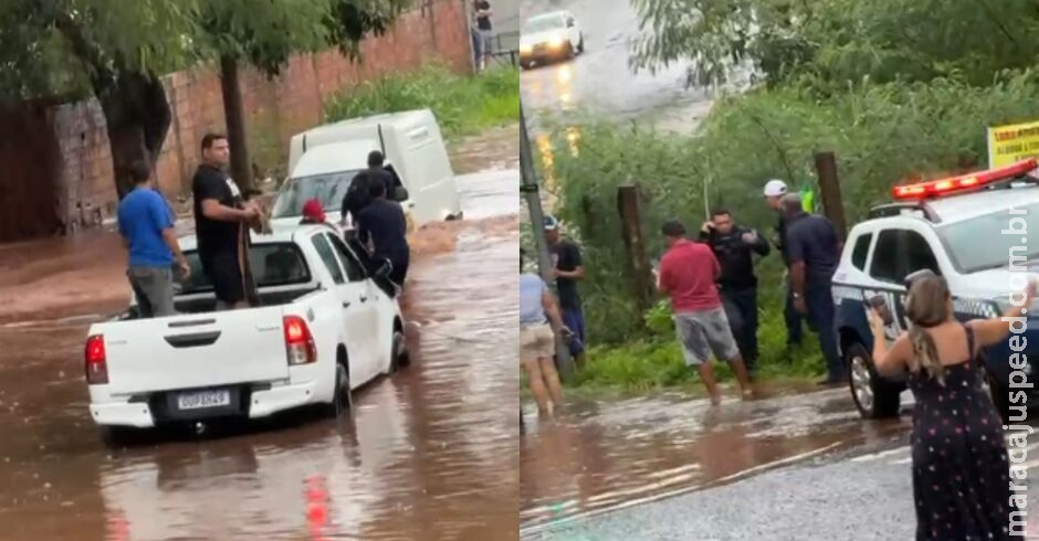 PMs resgatam três pessoas presas em carro durante alagamento no Jardim Morenão PMs resgatam três pessoas presas em carro durante alagamento no Jardim Morenão